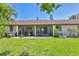 Spacious backyard with a well-maintained lawn, patio, and sliding glass doors that lead to the home at 6010 36Th Avenue W Cir # E, Bradenton, FL 34209