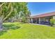 Well-manicured backyard featuring lush green lawn, mature trees, and a peaceful setting at 6010 36Th Avenue W Cir # E, Bradenton, FL 34209