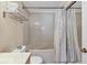 Bright bathroom featuring a tub/shower combo with white tile and neutral vanity with ample counter space at 6010 36Th Avenue W Cir # E, Bradenton, FL 34209