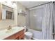 Bright bathroom featuring a tub/shower combo with white tile and neutral vanity with ample counter space at 6010 36Th Avenue W Cir # E, Bradenton, FL 34209