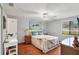 Bright bedroom with beach-themed decor, ceiling fan, and view from a window at 6010 36Th Avenue W Cir # E, Bradenton, FL 34209