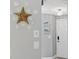 Bright entryway featuring decorative starfish, turtle art, and modern lighting at 6010 36Th Avenue W Cir # E, Bradenton, FL 34209