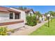 Pleasant exterior view of a townhome showing a tidy walkway and tropical plants at 6010 36Th Avenue W Cir # E, Bradenton, FL 34209