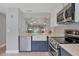 A view from the kitchen out into the living space and a water view at 6010 36Th Avenue W Cir # E, Bradenton, FL 34209