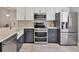 This kitchen offers stainless steel appliances, modern cabinetry and countertops at 6010 36Th Avenue W Cir # E, Bradenton, FL 34209