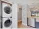 Convenient laundry area with stacked washer and dryer, located near kitchen with stainless steel appliances at 6010 36Th Avenue W Cir # E, Bradenton, FL 34209