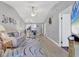 Open-concept living room with elegant decor, access to the kitchen, and lots of seating at 6010 36Th Avenue W Cir # E, Bradenton, FL 34209