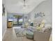 Cozy living room with sliding glass doors, stylish furnishings, and coastal decor at 6010 36Th Avenue W Cir # E, Bradenton, FL 34209