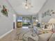 Inviting living room with comfortable seating, a ceiling fan, and access to the lanai at 6010 36Th Avenue W Cir # E, Bradenton, FL 34209