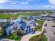 An aerial view showcases the clubhouse, pool, tennis courts, and surrounding neighborhood at 6244 Talon Preserve Dr, Nokomis, FL 34275