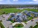 Aerial view of community clubhouse, pool, tennis courts, and surrounding neighborhood at 6244 Talon Preserve Dr, Nokomis, FL 34275