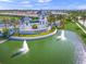 Aerial view of community entrance with water feature, landscaping, and decorative towers at 6244 Talon Preserve Dr, Nokomis, FL 34275