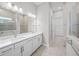 Bright bathroom with dual sinks and modern fixtures leads to the walk in closet at 6244 Talon Preserve Dr, Nokomis, FL 34275