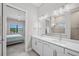 Bathroom with dual sinks and shower, offers an open view to the bedroom at 6244 Talon Preserve Dr, Nokomis, FL 34275