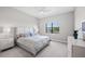 Carpeted bedroom with ceiling fan, features an abundance of natural light from the outdoor view at 6244 Talon Preserve Dr, Nokomis, FL 34275