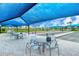 A covered outdoor bocce ball area with tables and seating, perfect for social gatherings and leisurely games at 6244 Talon Preserve Dr, Nokomis, FL 34275