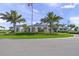 Stunning clubhouse with manicured landscaping, arched entryway, and classic architectural details at 6244 Talon Preserve Dr, Nokomis, FL 34275