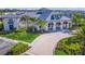 Beautiful clubhouse with a metal roof, arched entryway, lush landscaping, and a brick paver entrance at 6244 Talon Preserve Dr, Nokomis, FL 34275