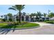 Attractive clubhouse exterior with lush greenery and a brick paved circular driveway at 6244 Talon Preserve Dr, Nokomis, FL 34275
