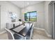 Bright dining room features a modern chandelier and view of the outdoors from the large picture window at 6244 Talon Preserve Dr, Nokomis, FL 34275