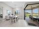 Bright dining area with a view of the lanai through sliding glass doors and stylish furniture at 6244 Talon Preserve Dr, Nokomis, FL 34275