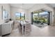 Bright dining room features a modern chandelier, neutral tones and sliding doors to the outdoor patio at 6244 Talon Preserve Dr, Nokomis, FL 34275