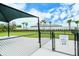 Gated area for small dogs features shade and a grassy run, creating a secure and enjoyable space at 6244 Talon Preserve Dr, Nokomis, FL 34275