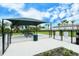 Fenced dog park with covered seating area and waste disposal, a safe space for dogs to play and socialize at 6244 Talon Preserve Dr, Nokomis, FL 34275