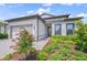 Well-manicured landscaping around a beautiful home with a paved driveway and a two-car garage at 6244 Talon Preserve Dr, Nokomis, FL 34275