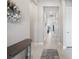 Bright hallway featuring neutral walls, ceramic tile flooring and an ornate table and wreath at 6244 Talon Preserve Dr, Nokomis, FL 34275