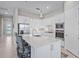 Contemporary kitchen featuring a large island, stainless appliances, and stylish pendant lights at 6244 Talon Preserve Dr, Nokomis, FL 34275