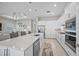 Bright, open kitchen with a center island, stainless steel appliances, and seamless flow to the living area at 6244 Talon Preserve Dr, Nokomis, FL 34275