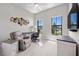 Bright office space featuring a plush chair, modern desk, and decorative wall art at 6244 Talon Preserve Dr, Nokomis, FL 34275