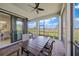 Spacious screened-in patio with a dining table, offering lovely views of the surrounding landscape at 6244 Talon Preserve Dr, Nokomis, FL 34275
