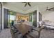 Covered patio featuring an outdoor dining area, comfortable seating, and scenic views at 6244 Talon Preserve Dr, Nokomis, FL 34275
