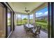 Screened patio with a ceiling fan, outdoor dining area, and beautiful backyard views at 6244 Talon Preserve Dr, Nokomis, FL 34275