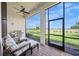 Screened patio featuring brick flooring, outdoor kitchen, ceiling fan, and views of lush landscaping at 6244 Talon Preserve Dr, Nokomis, FL 34275