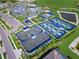 Aerial view of the tennis and pickleball courts within the community, all with pristine blue and green surfaces at 6244 Talon Preserve Dr, Nokomis, FL 34275