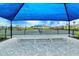 Community tennis courts with sun shelters, a bench, and landscaping at 6244 Talon Preserve Dr, Nokomis, FL 34275