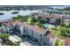 Scenic aerial view of a well-maintained complex featuring a pool, parking area, and waterfront access at 6285 Midnight Pass Rd # 403, Sarasota, FL 34242