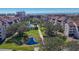 Aerial view of community featuring lush landscaping, swimming pool, pond, and multi-story buildings at 6285 Midnight Pass Rd # 403, Sarasota, FL 34242