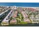 Aerial view showcasing waterfront community, including lush landscaping, pool, and nearby beach at 6285 Midnight Pass Rd # 403, Sarasota, FL 34242
