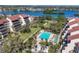 An aerial view of the building, pool and surrounding landscape at 6285 Midnight Pass Rd # 403, Sarasota, FL 34242