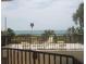 Balcony overlooking ocean and sand, with seating at 6285 Midnight Pass Dr # 403, Sarasota, FL 34242