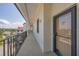 Exterior shot of unit 403 on a bright, sunny day, featuring a view of palm trees, building and waterway at 6285 Midnight Pass Rd # 403, Sarasota, FL 34242