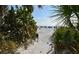 Beach access path with beach umbrellas and ocean view in the distance at 6285 Midnight Pass Rd # 403, Sarasota, FL 34242