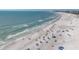 Expansive beach view with people, umbrellas, and the ocean stretching to the horizon at 6285 Midnight Pass Rd # 403, Sarasota, FL 34242