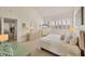 Bright bedroom featuring large windows, neutral colors, and a comfortable bed at 6285 Midnight Pass Rd # 403, Sarasota, FL 34242