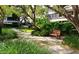 Secluded courtyard with bench seating and meticulously maintained landscaping at 6285 Midnight Pass Rd # 403, Sarasota, FL 34242