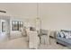 Bright dining room with a mirrored wall, a chandelier, and comfortable seating for elegant meals and gatherings at 6285 Midnight Pass Rd # 403, Sarasota, FL 34242